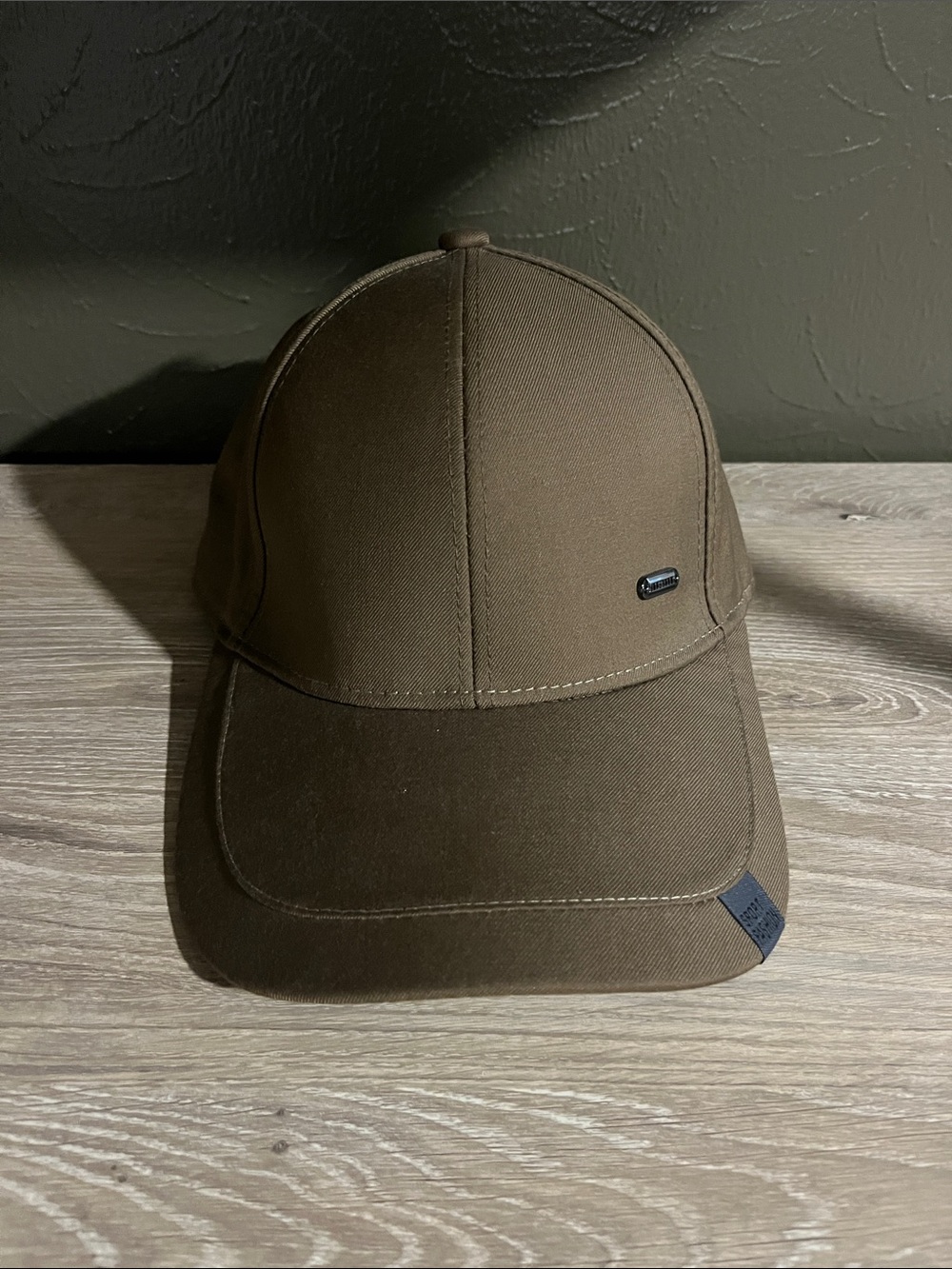 Brown Baseball Cap With Small Logo on Brim That Says “Sport Fashion”